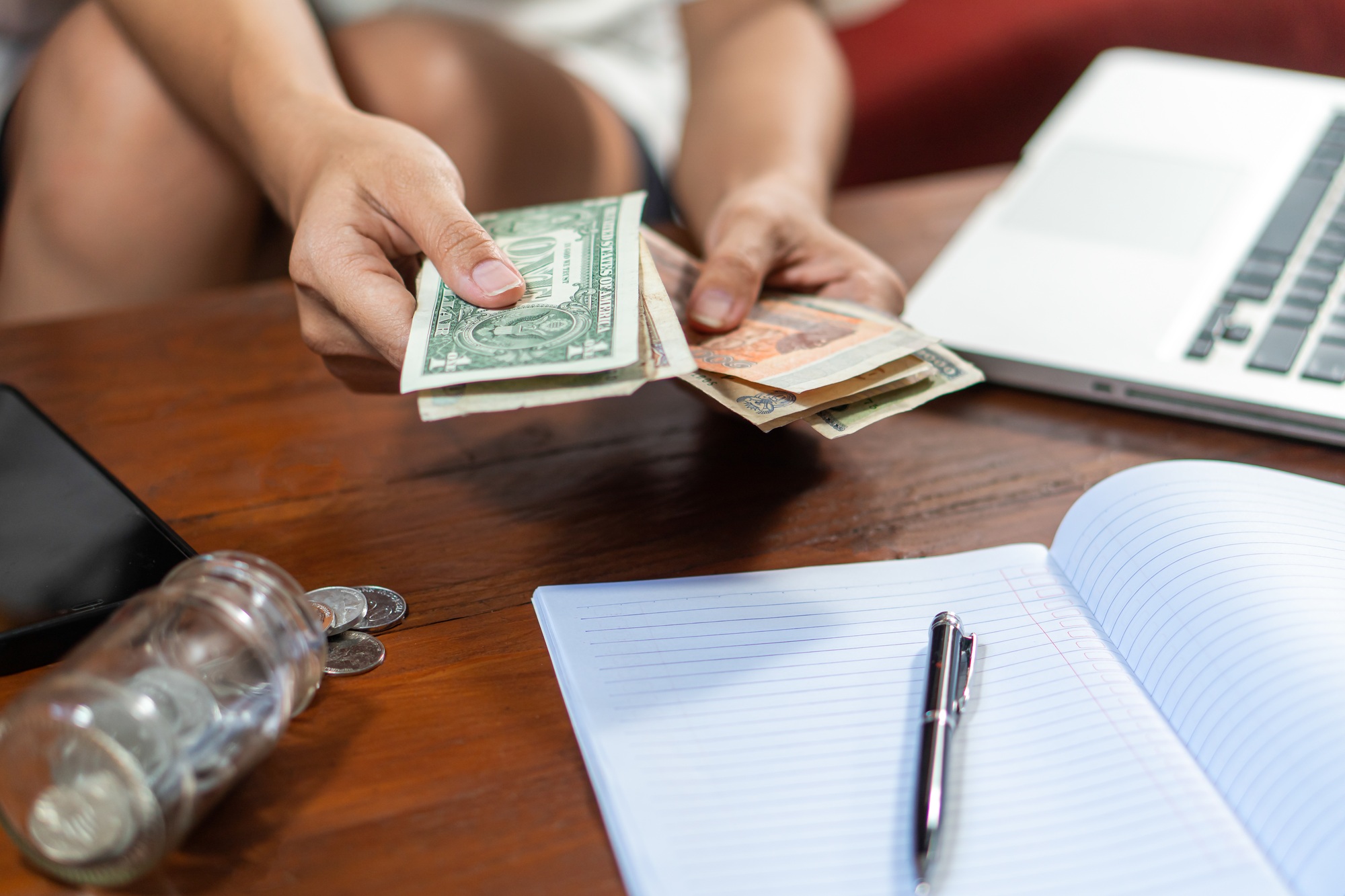 Young woman checking bills, taxes, bank account balance and calculating credit card expenses